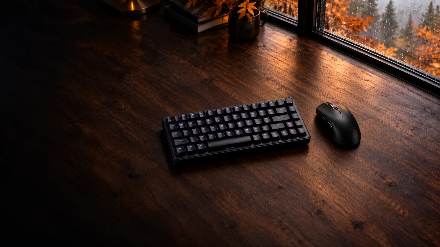 Black gaming keyboard and mouse on an autumn desk